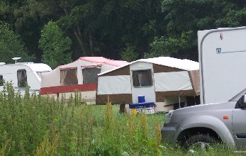 Trailer tents in long grass